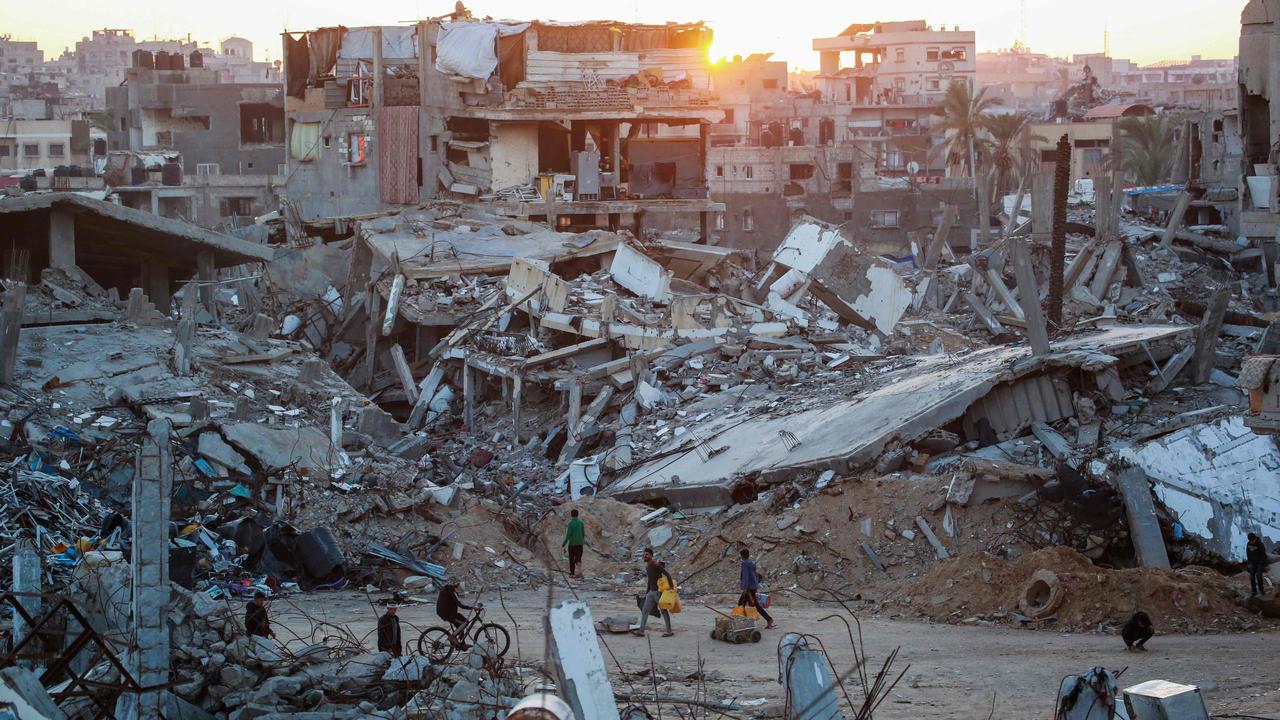 Palestinians walk in a devastated neighbourhood due to Israeli strikes in the southern Gaza Strip. Picture: AFP