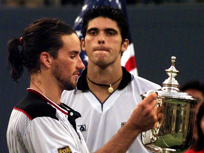 Aust tennis player Patrick Rafter (l) and trophy with Mark Philippoussis (r) after winning US Open tournament mens singles final 13 Sep 1998.