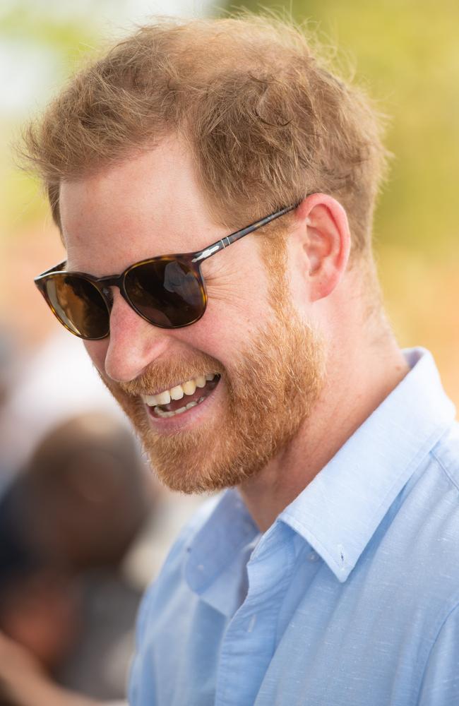 Prince Harry laughs during a visit to the Mauwa Health Centre. Picture: Getty Images