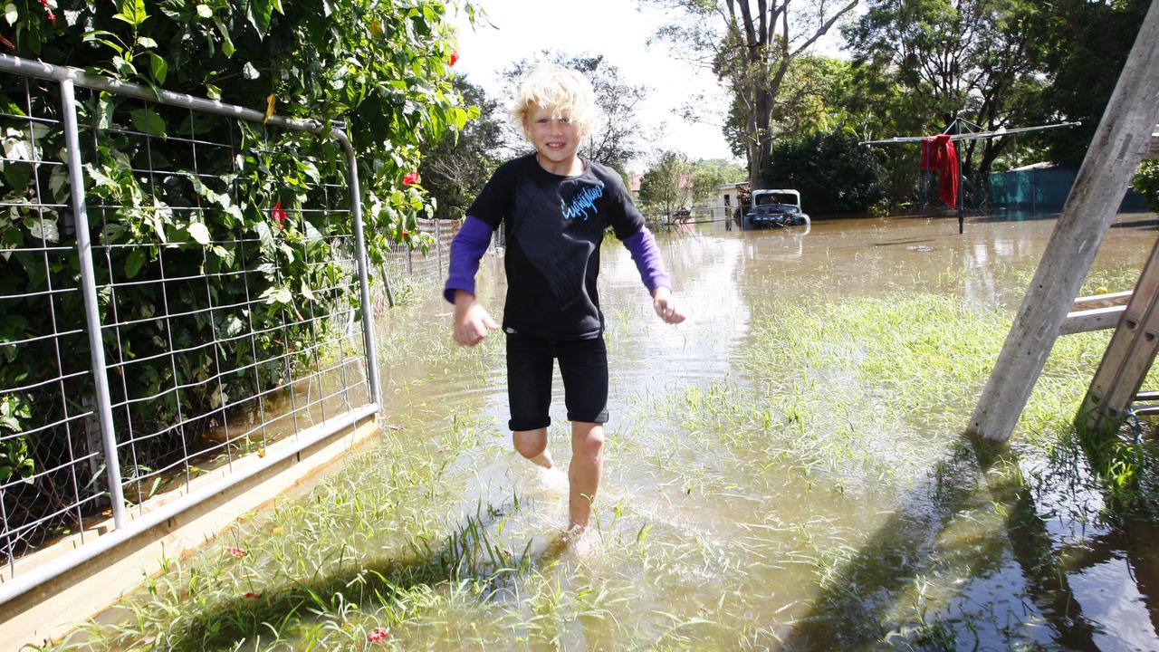 Tye Sherlock, 9, of North Booval playing in water in his back yard after the flooding. Photo: David Nielsen / Queensland Times