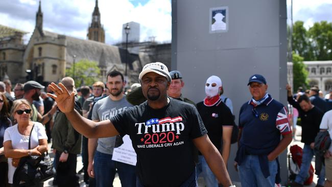 Members of far right groups gather around to guard the boarded-up statue of Winston Churchill in Parliament Square in central London on Saturday.