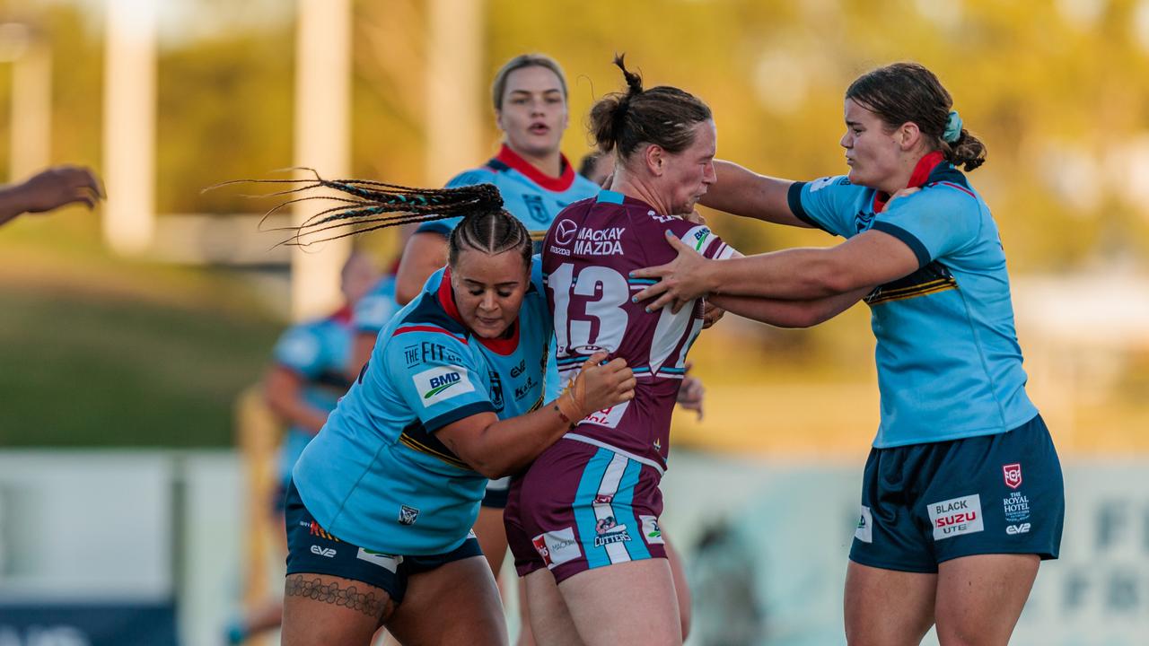 Jessikah Reeves and Mackenzie Zeller tackle a Mackay Cutters player. Picture: Benny Hassum Photography