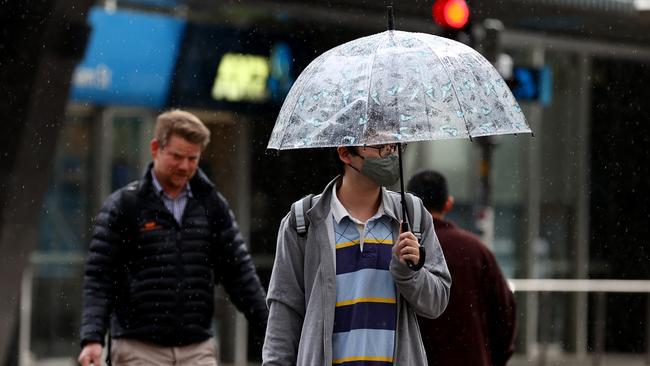 Pedestrians try to keep dry as Adelaide is hit with rain in September. Picture: NCA NewsWire / Kelly Barnes