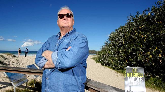 Greg Reed at Cabarita Beach with his popular book Murder Secret. Picture: Scott Powick