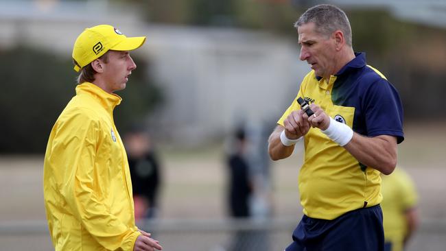 Goal and central umpires confer over a goal decision.