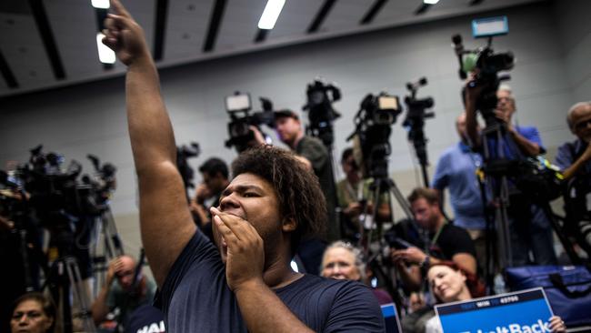 Aaron McCall, 27, cheers before former US President Barack Obama speaks at a Democratic Congressional Campaign Committee rally. Picture: Getty