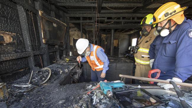 Techsafe investigator Richard Tattersall and fire investigators Darryl Hancock and Shayne Andrews look to determine the cause of a house fire in Devon St, South Burnie. Picture: GRANT WELLS