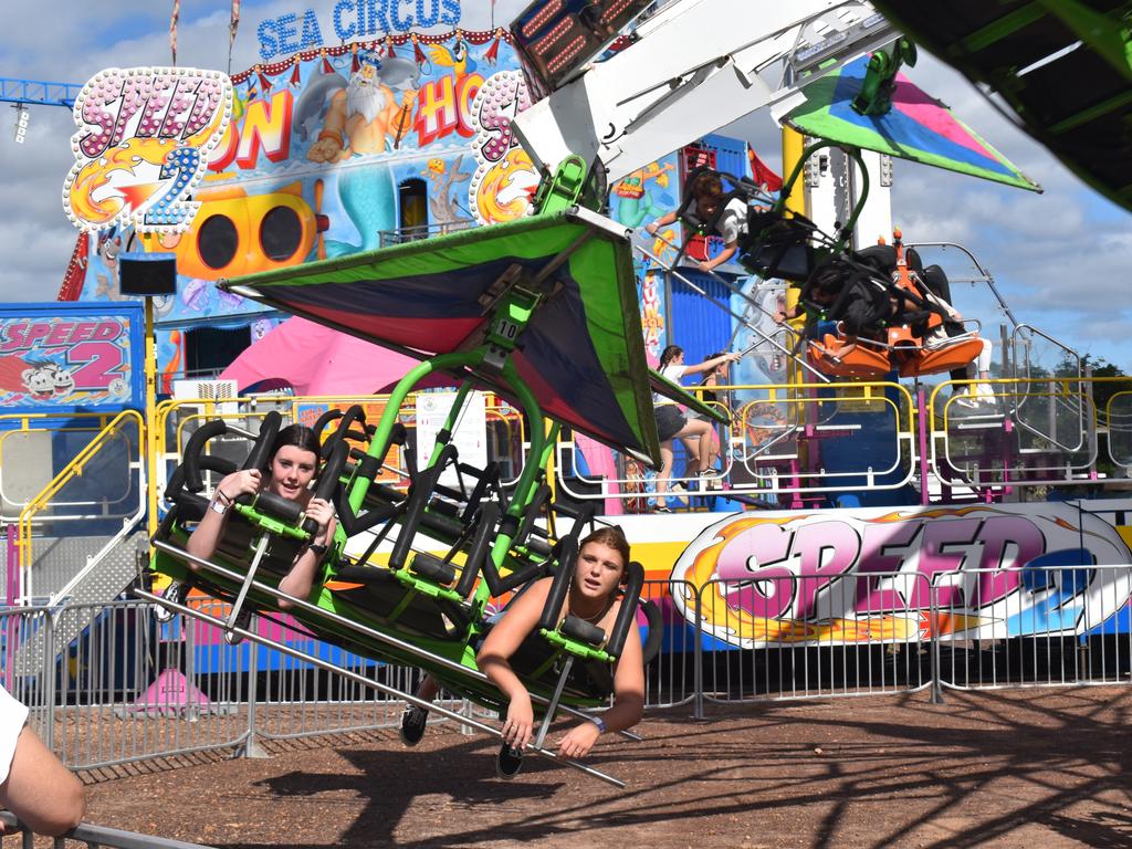 (L) Tayissa Richters and Rosie White fly through the air on the Cliff Hanger ride at the Fraser Coast Ag Show.