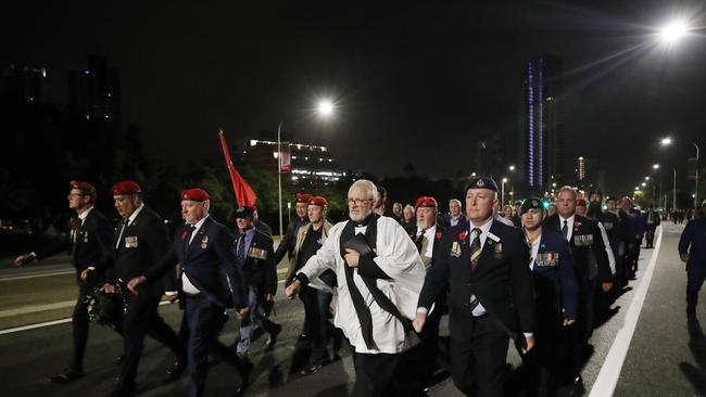 Dawn Service at Southport. an unauthorised march makes its way down the Gold Coast Highway. Picture Glenn Hampson