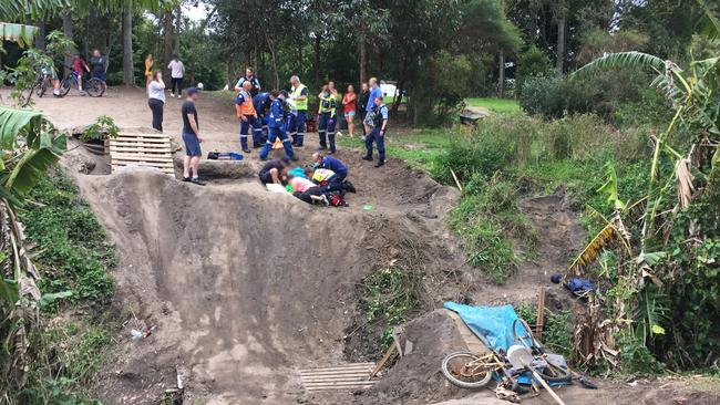 Emergency services attend to a boy who was injured while riding a jump ramp in a reserve at Mona Vale, which has been removed. Picture: CareFlight