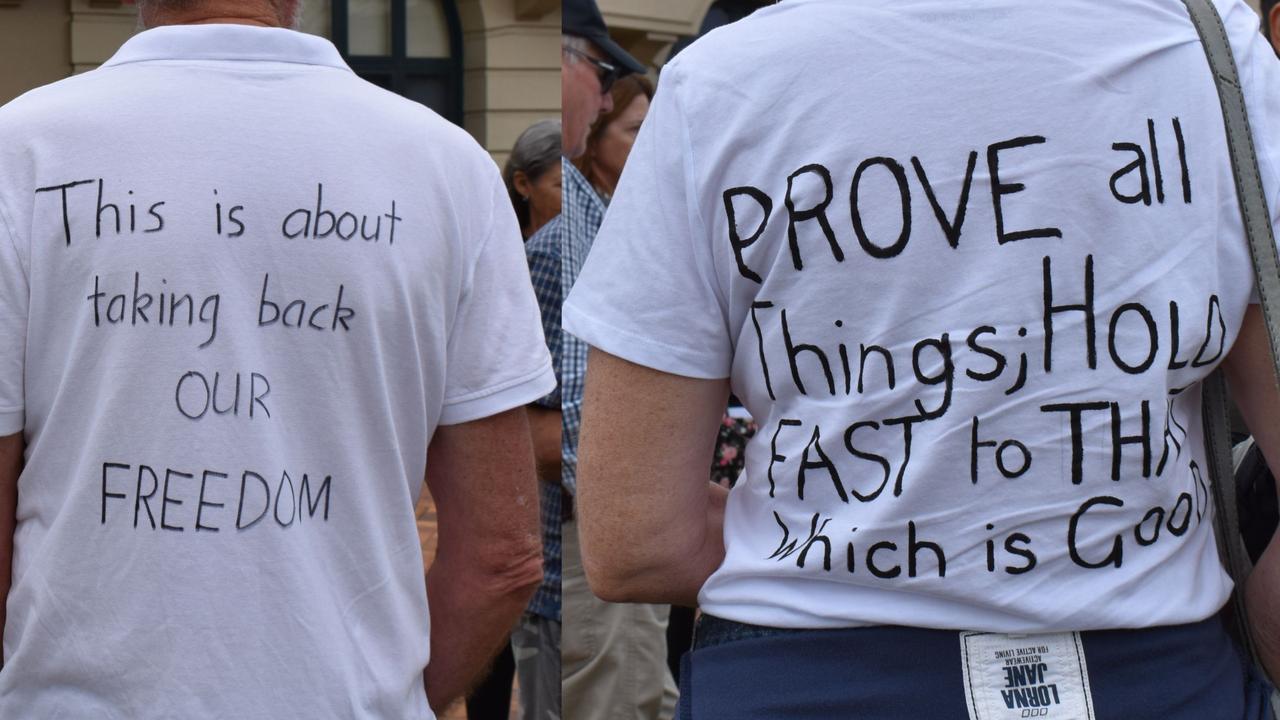 Some protesters wore shirts conveying their message of freedom, with one protester (right) wearing a shirt quoting a verse from the bible.