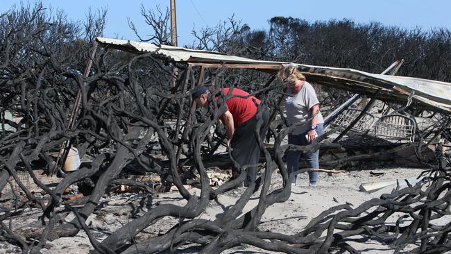 Glenda Wilby and Brently Golder look at what’s left of their shack. Picture: Emma Brasier