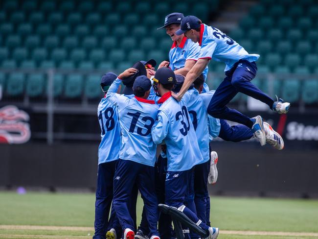 NSW Metro players celebrate taking the match sealing wicket against Queensland in the under-17 national cricket championships final at Launceston on Thursday. Picture: Linda Higginson/Cricket Australia (EDITORIAL USE ONLY)