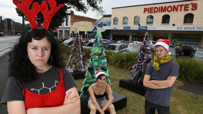 Fitzroy North locals Mafi Watson, Anne-Marie O' Brien and Kye Brown aren’t feeling particularly festive, thanks to the council’s lacklustre Christmas decorations. Picture: Stuart Milligan