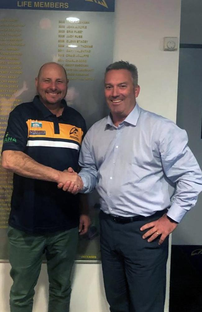 Welcome, Mighty Mick: Fogarty shakes on it with Beaconsfield president Troy Robinson.