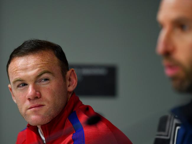 Wayne Rooney listens to England manager Gareth Southgate.