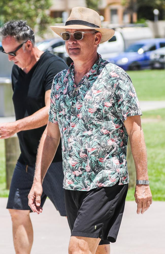 Hanks went unnoticed by beachgoers in a hat, sunglasses and Hawaiian shirt. Picture: Nigel Hallett