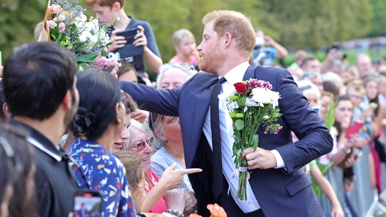 Prince Harry, Duke of Sussex leans in to get flowers from the crowd. (Photo by Chris Jackson - WPA Pool/Getty Images)