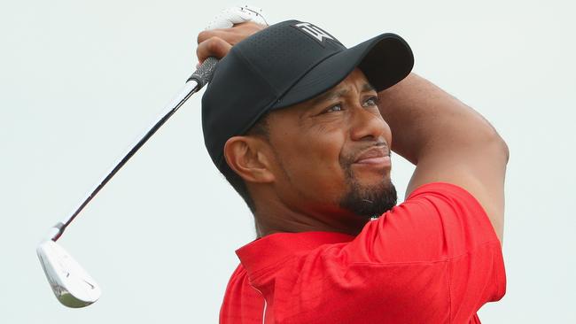 Tiger Woods hits his tee shot on the second hole.