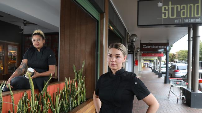 The Strand staff members, Fi and Nelle, outside of the restaurant, showing a quiet Jetty Road. The tourist strip has been described as a ghost town because of coronavirus, and the Grand hotel closing, will further affect the precinct. Picture: Dean Martin