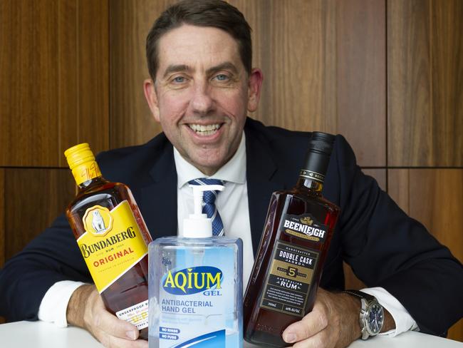 Minister Cameron Dick with bottles of Bundaberg Rum and Beenleigh Rum.