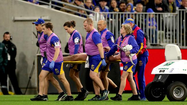 Daniel Venables of the Eagles is stretchered off the field by medics. Picture: Richard Wainwright