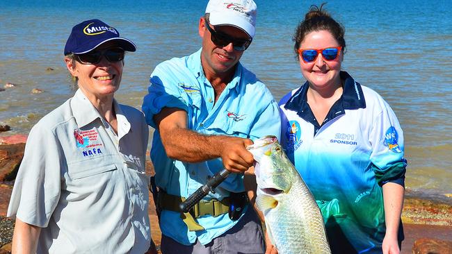 Christine Mansfield, Helifish pilot Ryan Saywell and Jenny Mansfield with Jenny’s silver barra caught on her first cast the very first time she has ever gone fishing