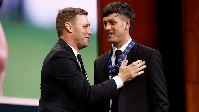 Zak Butters of the Power is presented with the AFLCA Champion Player of the Year award by Sam Mitchell. Picture: Daniel Pockett/AFL Photos