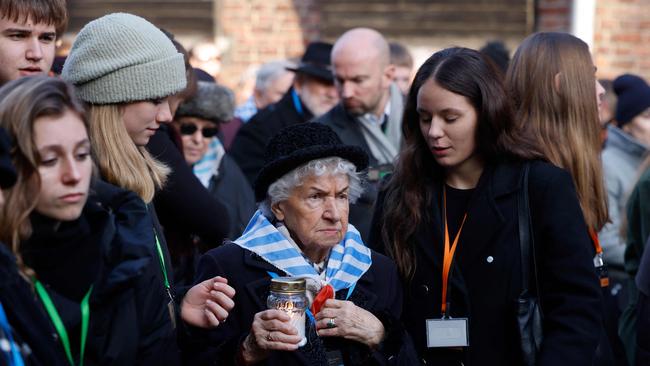 Holocaust survivors and their relatives light candles and lay wreaths at Auschwitz on Monday. Picture: AFP