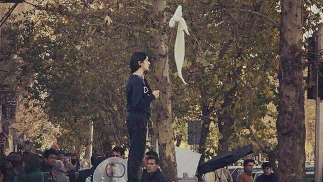 A lone Iranian woman having removed her hijab and placing at the end of a stick has become a symbol of protest in Iran. Source: Supplied.