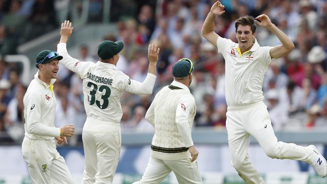 Australia's Pat Cummins, right, celebrates after taking the wicket of England's Joe Root. Picture: AP