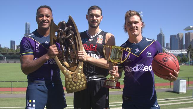 Felise Kaufusi, Chris Goulding and Ryan Papenhuyzen with the NBL and NRL trophies.