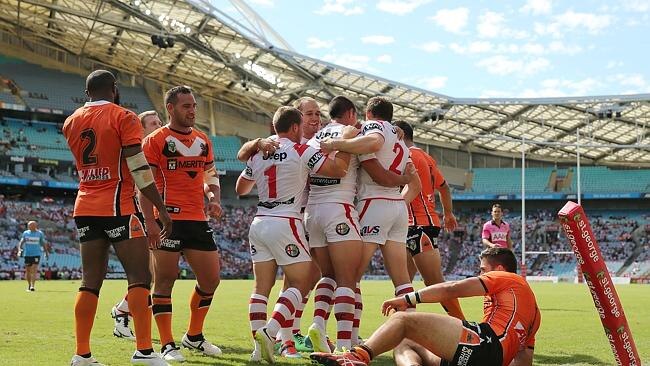 Gerard Beale of the Dragons celebrates with team mates after scoring a try.