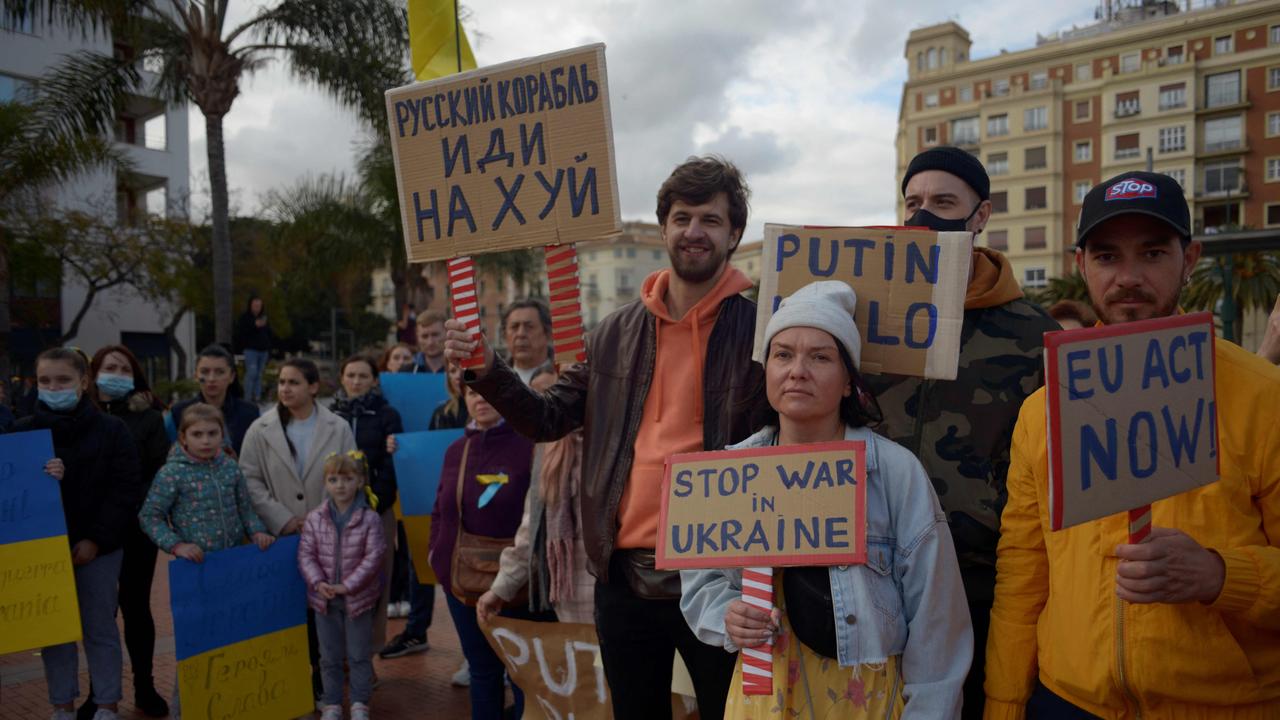 Demonstrators hold signs during a protest against Russia's invasion of Ukraine. Picture: AFP