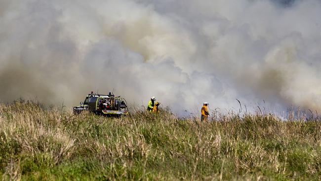 Firefighters work to extinguish a fire at Mudgeeraba Rd, Mudgeeraba. Photo: Jerad Williams