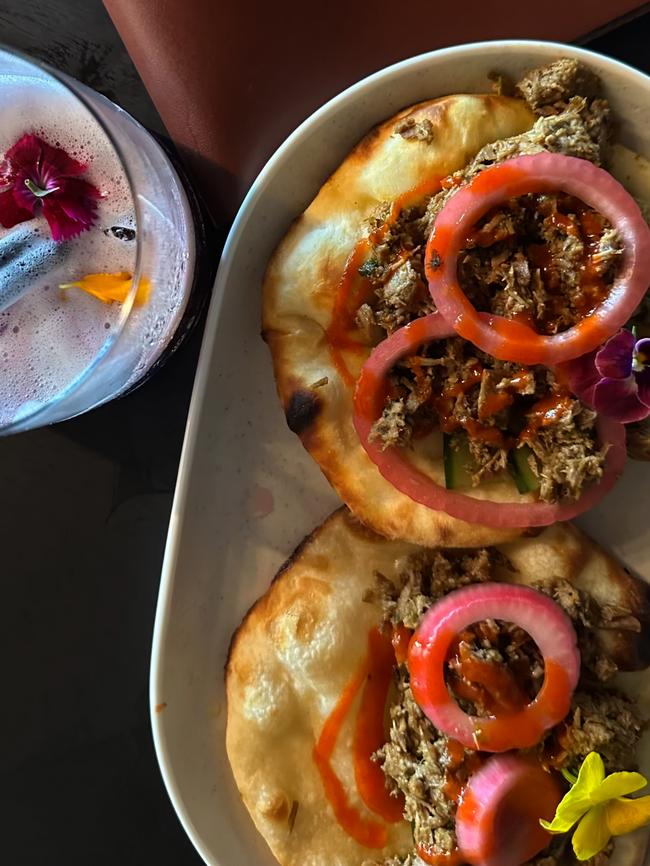 Slow cooked lamb served on a baby naan and topped with pickled onion rings and sriracha sauce. Picture: About Media Group