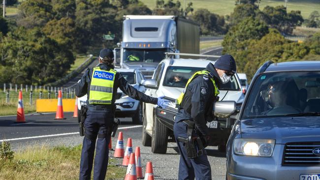 Police inspect cars at a checkpoint at Sunbury on the Calder Freeway. Picture Jay Town