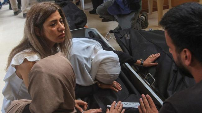 People mourn by the bodies of relatives killed in a September 29 Israeli strike on Ain El Delb, during their funeral in the nearby city of Sidon, southern Lebanon, on October 1. Picture: Mahmoud Zayyat/AFP