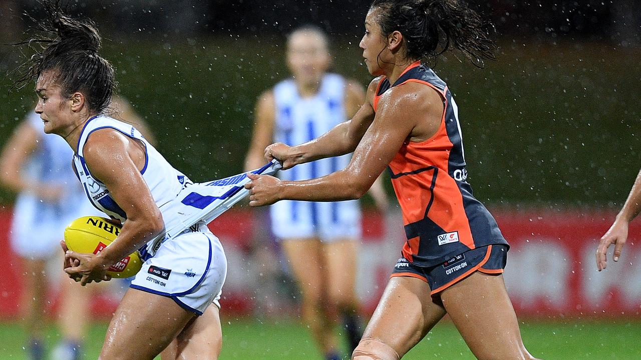 Ash Riddell is tackled by Rebecca Beeson at Drummoyne Oval. Picture: AAP