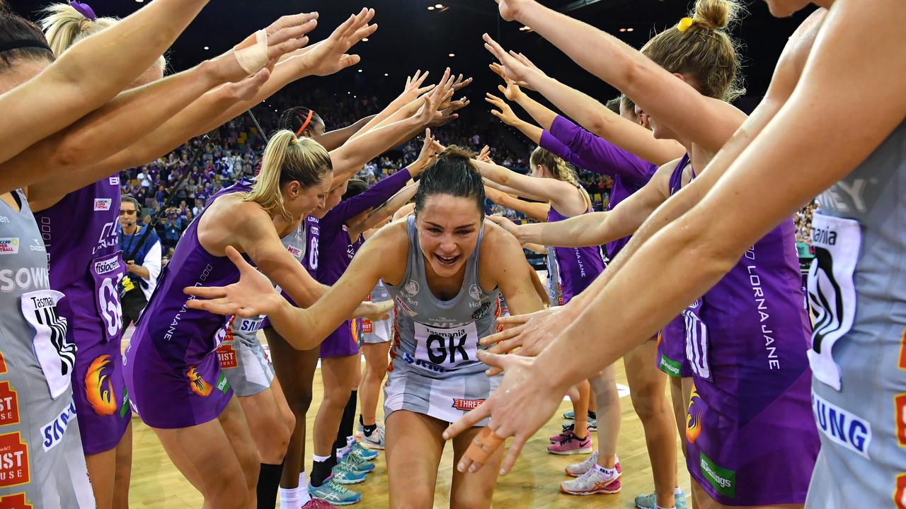 Sharni Layton (centre) is given a guard of honour after her last netball game.