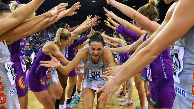 Sharni Layton (centre) is given a guard of honour after her last netball game.