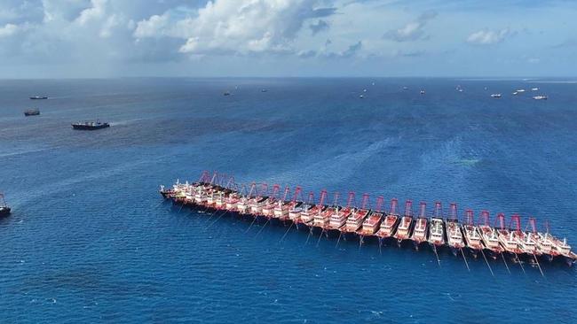 Chinese vessels gathered by Whitsun Reef, around 320 kilometres west of Palawan Island, in disputed waters of the South China Sea. Picture: Handout / Philippine Coast Guard