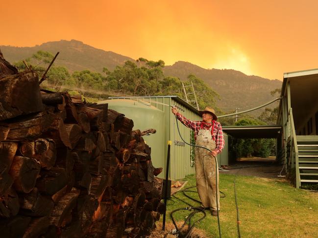 A bushfire burning in the Grampians National Park heads towards the township of Halls Gap. Paul and Eileen Turner defend their property.