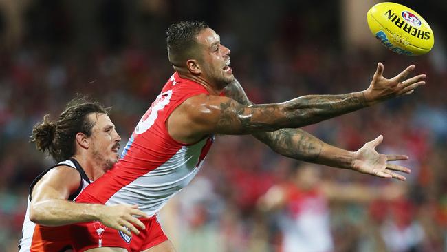 Sydney’s Lance Franklin juggles a mark ahead of Giants skipper Phil Davis. Picture: Phil Hillyard