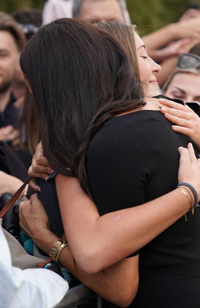 Meghan receives a hug from a wellwisher at Windsor Castle. Picture: AFP