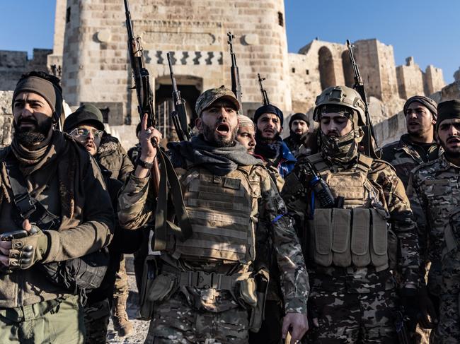 30 November 2024, Syria, Aleppo: Members of the Syrian armed opposition forces stand in front of the Ancient Castle of Aleppo after seizing control of most parts of Syria's second largest city. Photo: Anas Alkharboutli/dpa (Photo by Anas Alkharboutli/picture alliance via Getty Images)