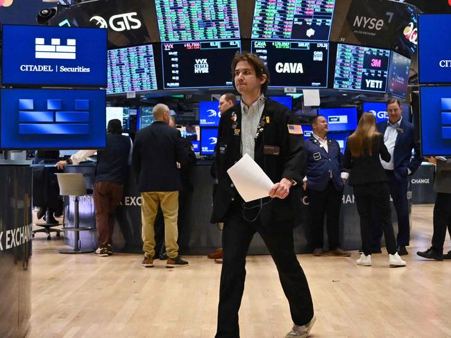 (FILES) In this file photo taken on November 13, 2024, traders work on the floor of the New York Stock Exchange (NYSE) at the opening bell in New York City. Wall Street stocks opened higher Monday as investors reacted positively to Donald Trump's Treasury Department pick at the start of a holiday-shortened week that will include economic data and earnings reports. (Photo by ANGELA WEISS / AFP)