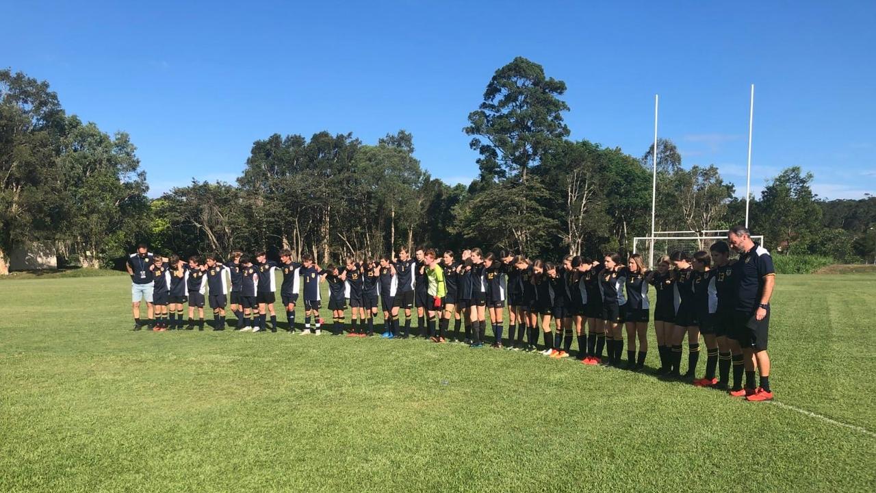 Immanuel Lutheran College soccer teams observing a minute silence for their classmate Saxony Walker who tragically passed away. Picture: Facebook