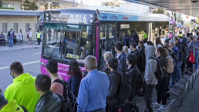 Commuters wait for buses at Epping train station this morning. Picture: Dylan Robinson