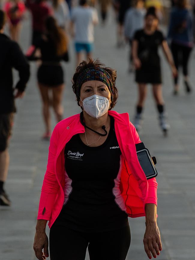 A woman wears a protective face mask as she exercises outdoors in Barcelona. Picture: Getty Images